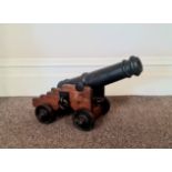 A 19th century cast iron signal cannon, 40cm On wooden trolley base.