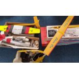 An assortment of RC Model Plane accessories and pieces to include, fuselage, wings, controllers