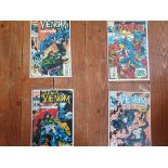 A collection of four Venom comics