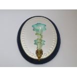 A Victorian mirror with blue velvet border, with a blue and turquoise glass Epergne trumpet