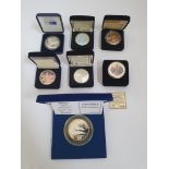 A collection of seven Silver Commerorative coins to include The 2005 and 2003 Holgram Silver Eagle