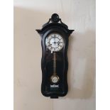 An ebonised black case wall clock.