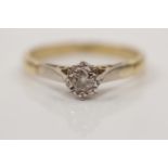 A diamond solitaire ring, illusion set with a round brilliant cut diamond measuring approx. 0.