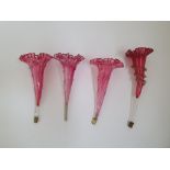 A collection of four Victorian cranberry Epergne trumpets.