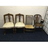 A wheel-back armchair, two oak tub style chairs and a rush seated chair.