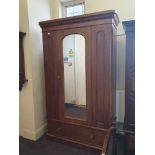 A victorian arch-top single door wardrobe.