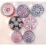 A collection of John Deacon glass paperweights of Millefiori design.