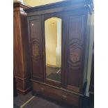 An Edwardian single mirror-door wardrobe.