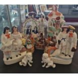 Twelve Staffordshire figures to include courting couples and dogs.