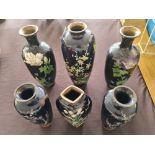 Six dark blue cloisonné vases with floral design.