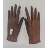 A pair of wooden glove stretchers.