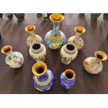 Nine cloisonné vases with floral design.