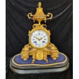 A French gilded bronze mantle clock with urn to top and bow on wooden base.approx 35cm.