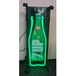 A 7UP advertising neon sign in the form of a bottle.