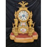 A French gilded mantle clock with female columns with two hand painted Sevres style panels of