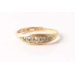 A hallmarked 18ct yellow gold five stone diamond boat ring, set with five graduated old cut