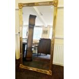 A large gilt framed wall mirror.