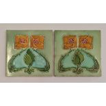 A pair of Minton tiles with art nouveau floral design.