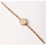 A hallmarked 9ct yellow gold Garrard ladies wrist watch, the cream dial having alternating Arabic