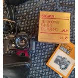 A Sigma DL lens Ricoh camera and a Nikon coolpix P500.
