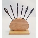 Six Japanese samurai Yanone arrow heads in wood stand.