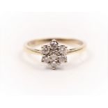 A hallmarked 9ct yellow gold diamond cluster ring, set with seven round brilliant cut diamonds in