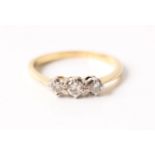 A three stone diamond ring, set with three graduated round brilliant cut diamonds, total diamond