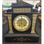 A black slate architectural style mantle clock.