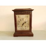 A mahogany-cased silver-faced bracket clock with three dials to face.