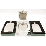 Four white metal hip flasks.