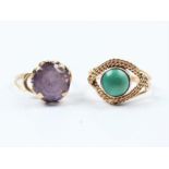 A reconstituted turquoise single stone ring together with an amethyst single stone ring, both