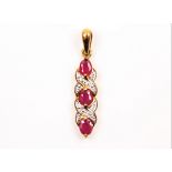 A hallmarked 9ct yellow gold ruby and diamond pendant, set with three oval cut rubies separated by