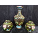 A pair of cloisonné ginger jars with vase.