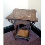 A small oak heavily carved Anglo-Indian table.