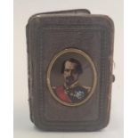 A miniature painting of Eugene de Beauharnais in leather purse with eagle holding lightning bolts on