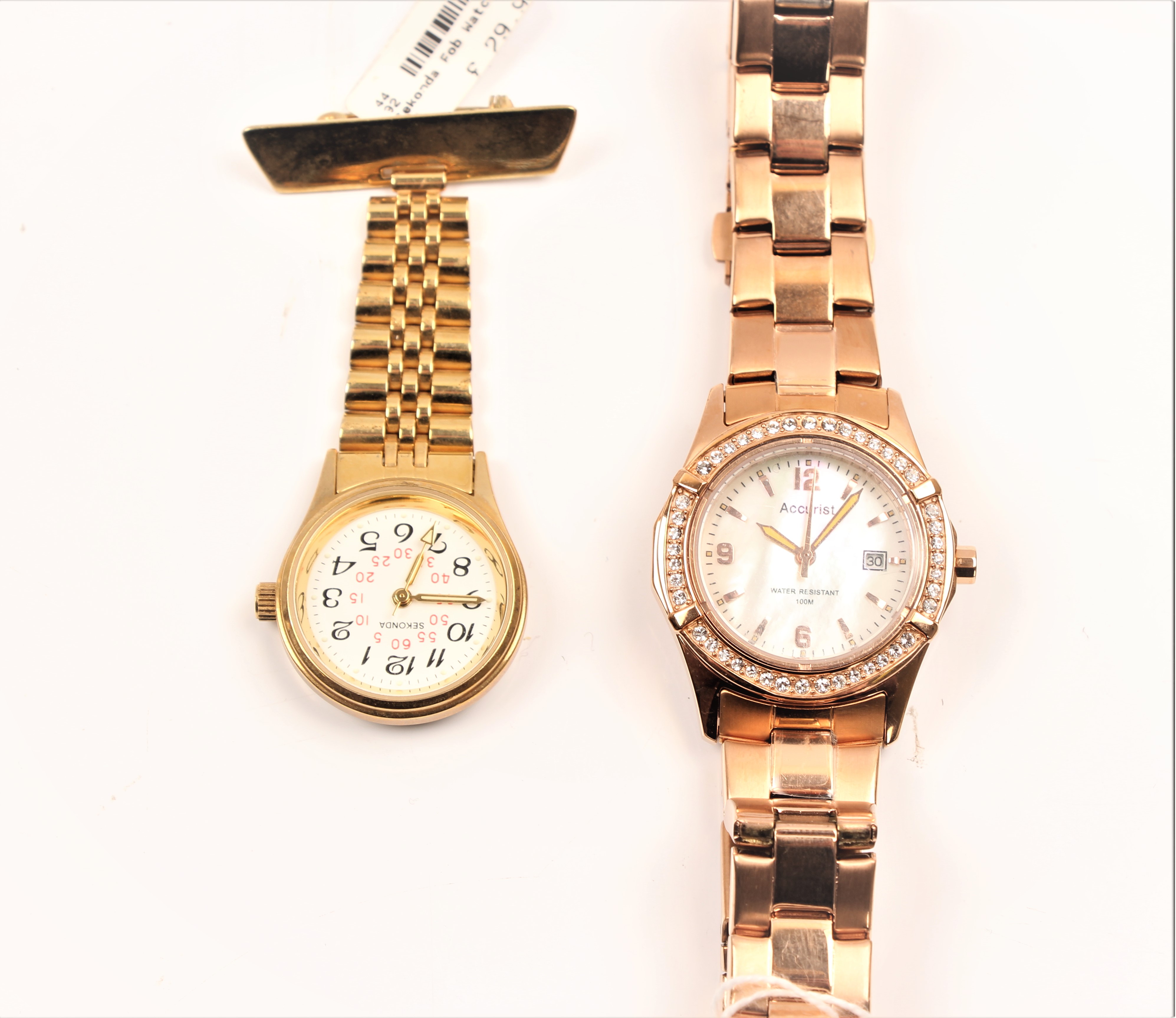 An ACCURIST wrist watch on bracelet strap along with a SEKONDA nurses watch.