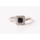 A hallmarked 18ct white gold sapphire and diamond ring, set with a central square cut sapphire