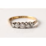 A hallmarked 18ct yellow gold five stone diamond ring, set with five graduated round brilliant cut