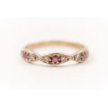 A hallmarked 9ct yellow gold ruby and cubic zirconia half eternity ring, ring size O