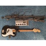 A Fender Bass (two strings missing) together with a ToneWorks Korg pedal board, and a collection