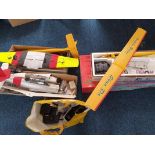 An assortment of RC Model Plane accessories and pieces to include, fuselage, wings, controllers