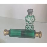 A green glass double end perfume bottle and one silver topped bottle.