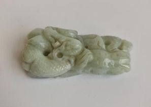 A green jade pendant with a dragon. Approx length 6cm.