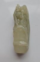 A pale green jade carving of a bamboo shoot with tree blossom. Approx length 7.5cm.