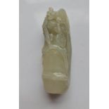 A pale green jade carving of a bamboo shoot with tree blossom. Approx length 7.5cm.