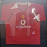 A signed Manchester United framed and glazed football top, sponsored by Vodafone.