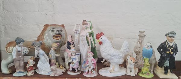 A collection of various china ornaments to include Beswick budgie, Nao figures, chicken, lion etc.