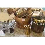 A collection of brass and copper to include candlestick cole bucket and lamp.