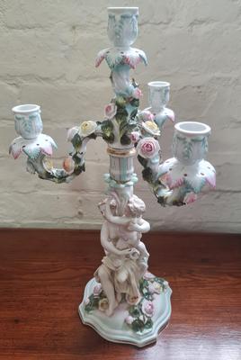 A Meissen cherub candelabra.