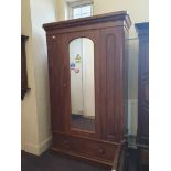 A Victorian arch-top single door wardrobe.